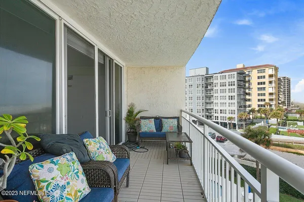 a balcony with furniture and rug