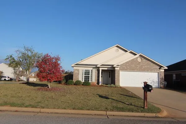 a view of a house with a yard and garage