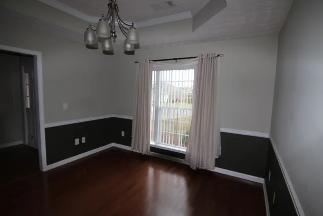 a view of room with window hardwood floor and ceiling fan