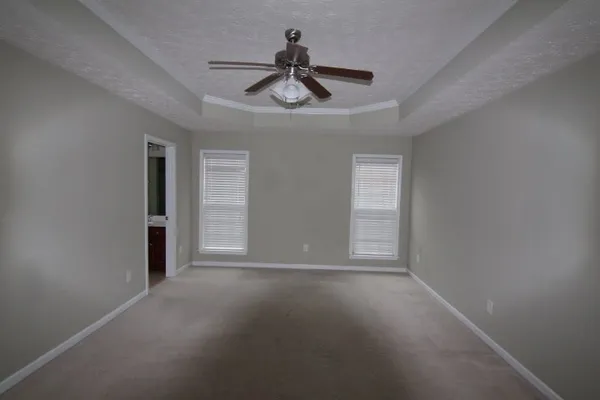 a view of empty room with ceiling fan