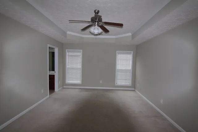 a view of empty room with ceiling fan