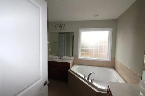 a bath room with a bath tub and a sink