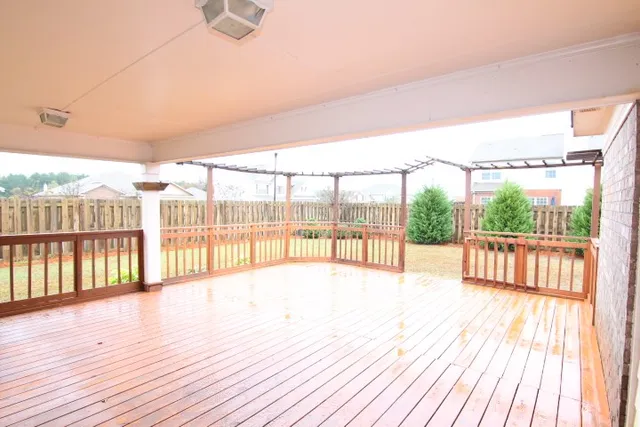 a view of hallway with wooden floor and fence