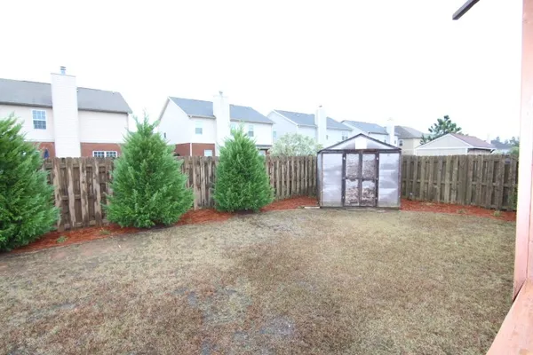 a view of a house with a yard and plants