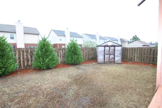 a view of a house with a yard and plants