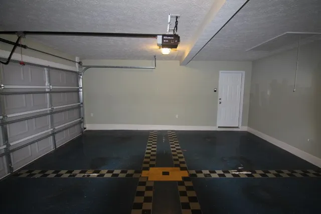 view of a room with water heater and wooden cabinets