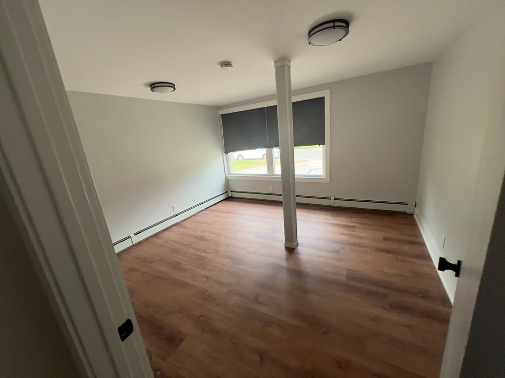 60 Corcoran Boulevard Springfield, MA 01118 - Photo 14 of 30 an empty room with wooden floor and windows