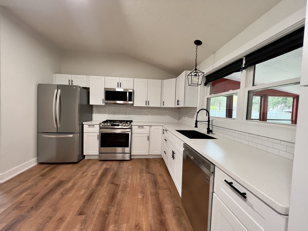 60 Corcoran Boulevard Springfield, MA 01118 - Photo 4 of 30 a kitchen with a sink a counter top space stainless steel appliances and a window