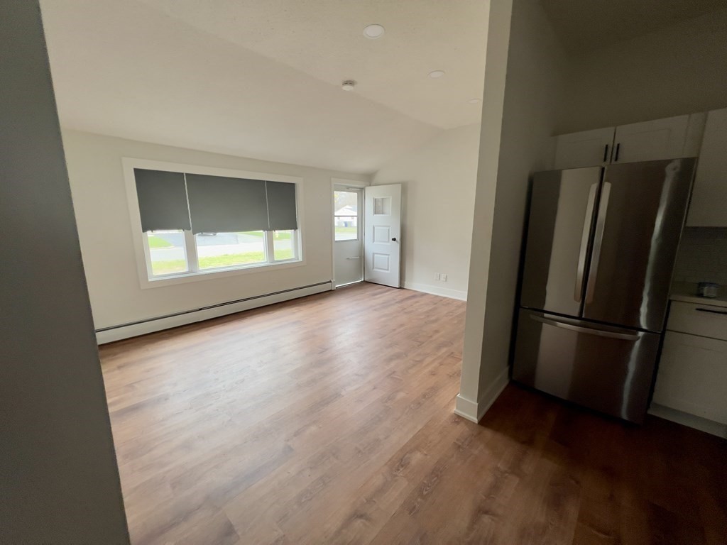 60 Corcoran Boulevard Springfield, MA 01118 - Photo 8 of 30 an empty room with a window and a refrigerator
