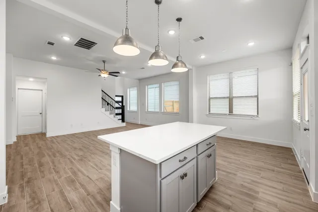 a kitchen with a stove and a chandelier