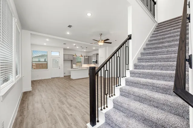 a view of staircase with white walls and windows