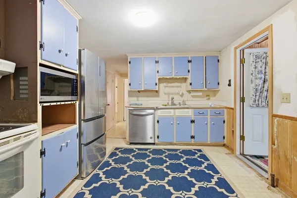 a kitchen with a stove microwave and cabinets