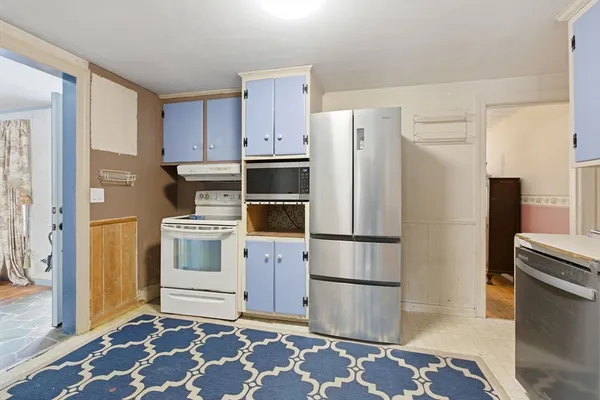 a kitchen with a refrigerator sink and stove