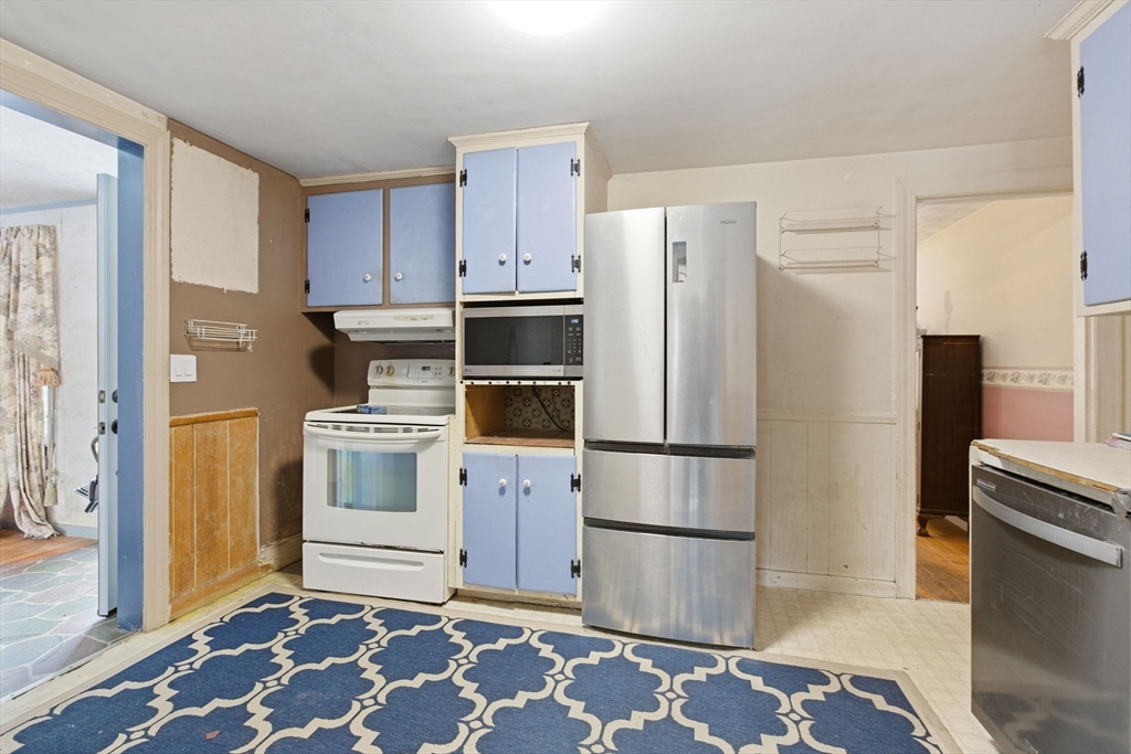 71 Liberty Street Acton, MA 01720 - Photo 9 of 13 a kitchen with a refrigerator sink and stove