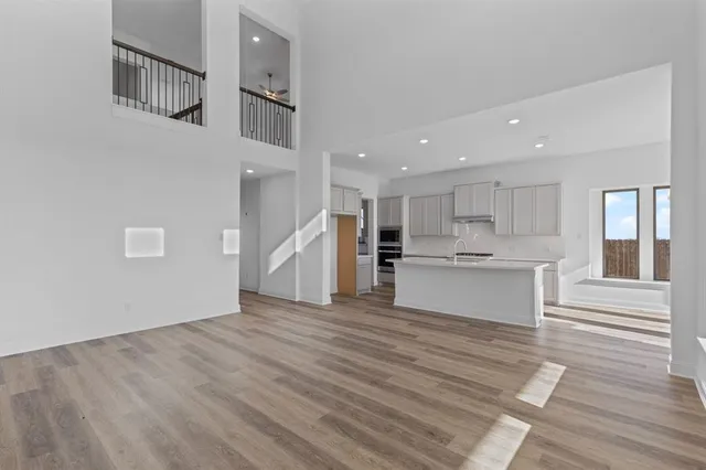 a view of kitchen with wooden floor and electronic appliances