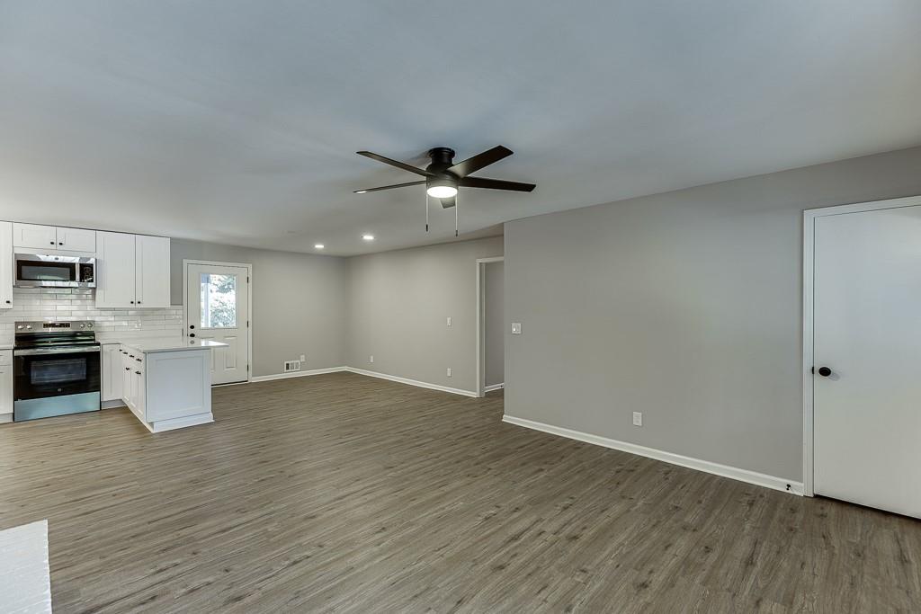 5837 Meadow View Lane Flowery Branch, GA 30542 - Photo 11 of 47 a view of an empty room with a kitchen