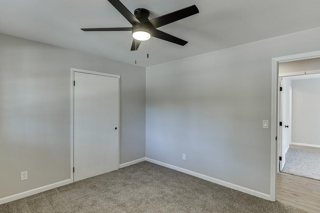 5837 Meadow View Lane Flowery Branch, GA 30542 - Photo 26 of 47 an empty room with a ceiling fan and a fan