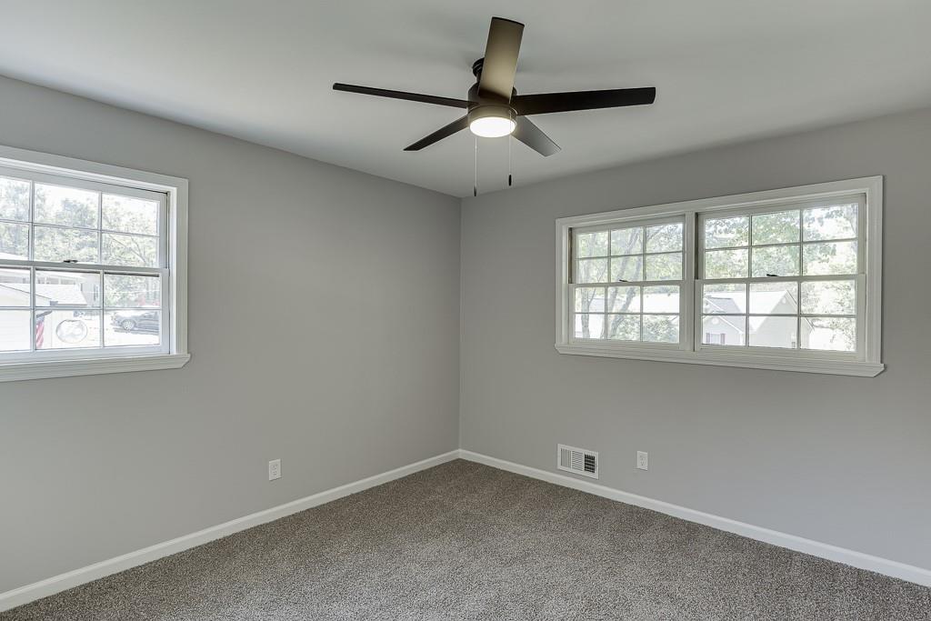 5837 Meadow View Lane Flowery Branch, GA 30542 - Photo 28 of 47 an empty room with a window and a fan