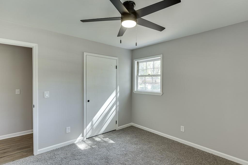 5837 Meadow View Lane Flowery Branch, GA 30542 - Photo 29 of 47 wooden floor in an empty room with a window