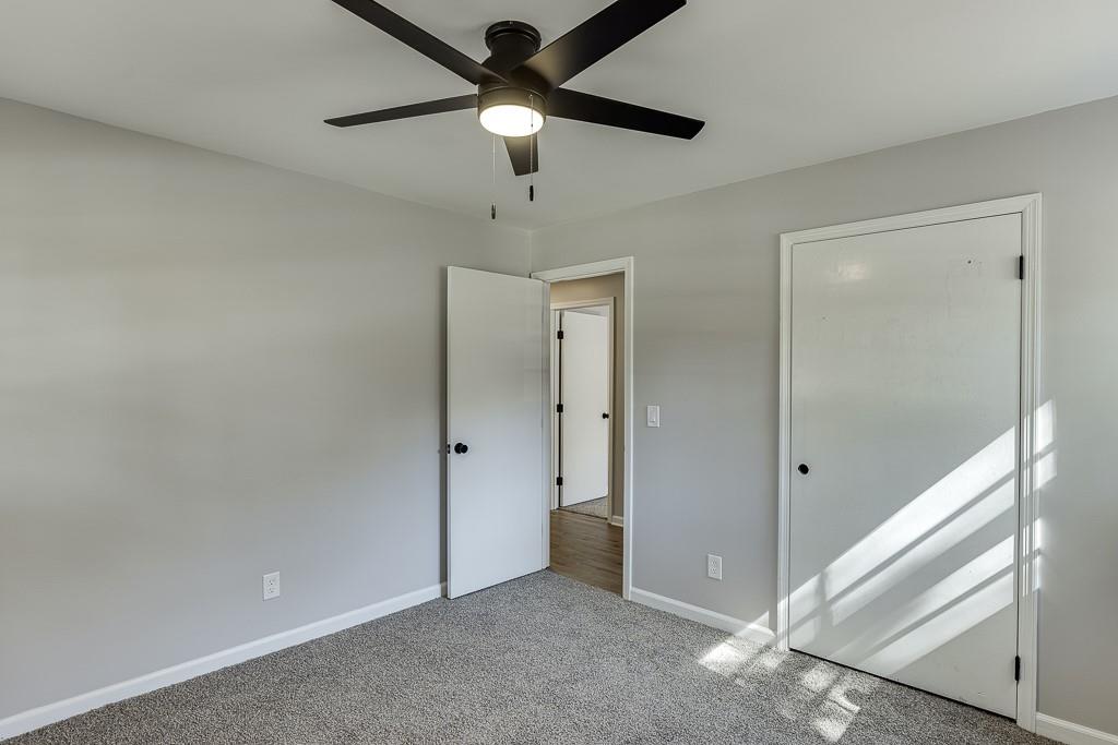 5837 Meadow View Lane Flowery Branch, GA 30542 - Photo 30 of 47 a view of an empty room and a ceiling fan