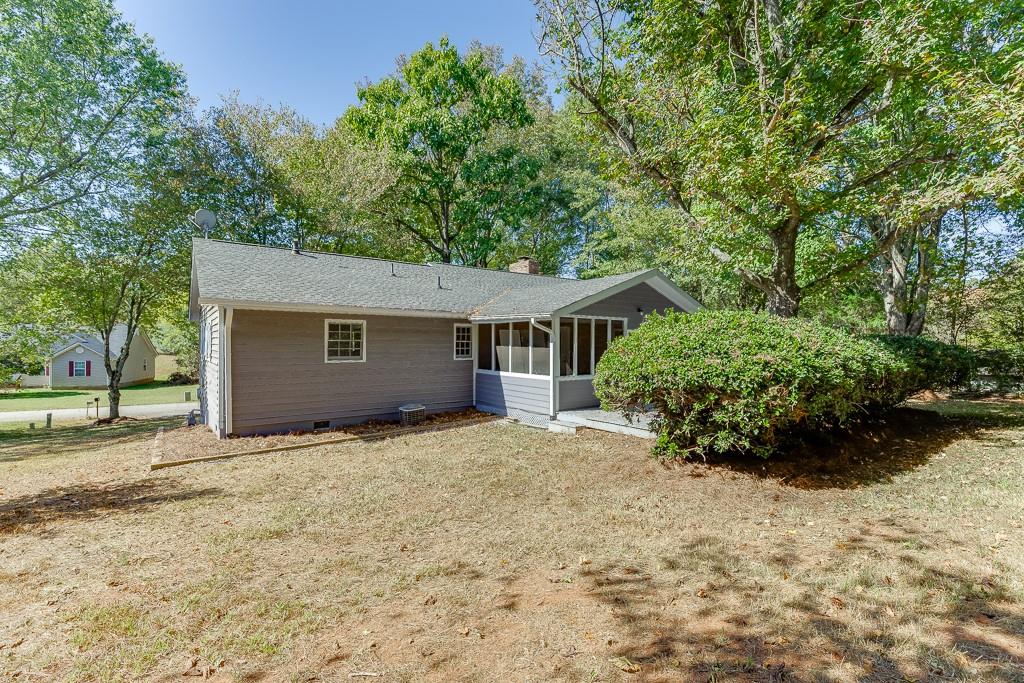 5837 Meadow View Lane Flowery Branch, GA 30542 - Photo 39 of 47 a view of a house with a yard and large trees