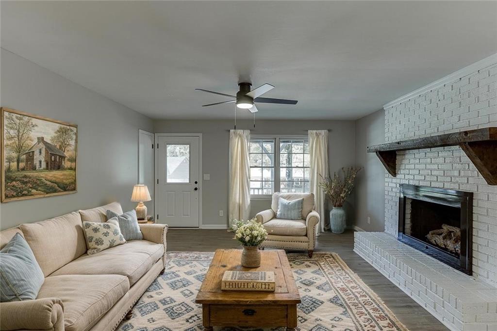5837 Meadow View Lane Flowery Branch, GA 30542 - Photo 5 of 47 a living room with furniture a window and a fireplace