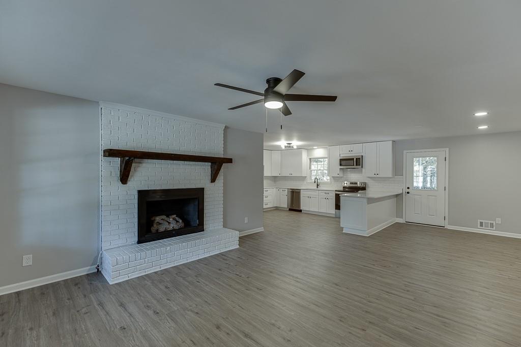 5837 Meadow View Lane Flowery Branch, GA 30542 - Photo 9 of 47 a living room with furniture and a fireplace