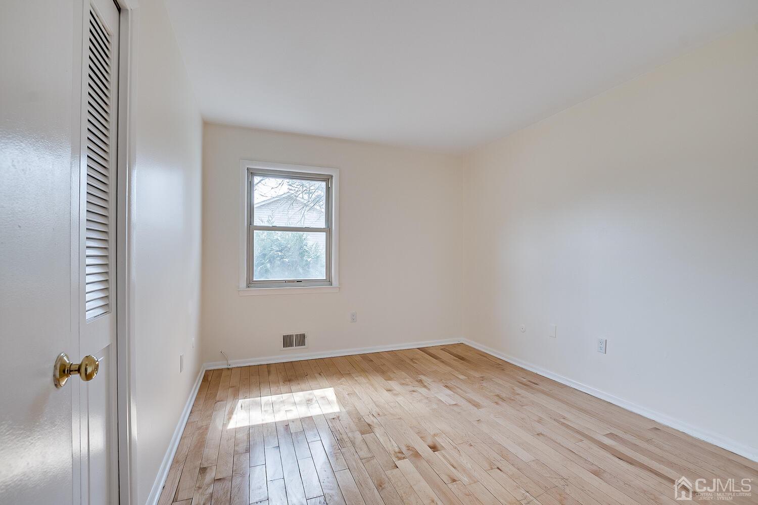 5 Robin Road Edison, NJ 08820 - Photo 22 of 43 an empty room with wooden floor and windows
