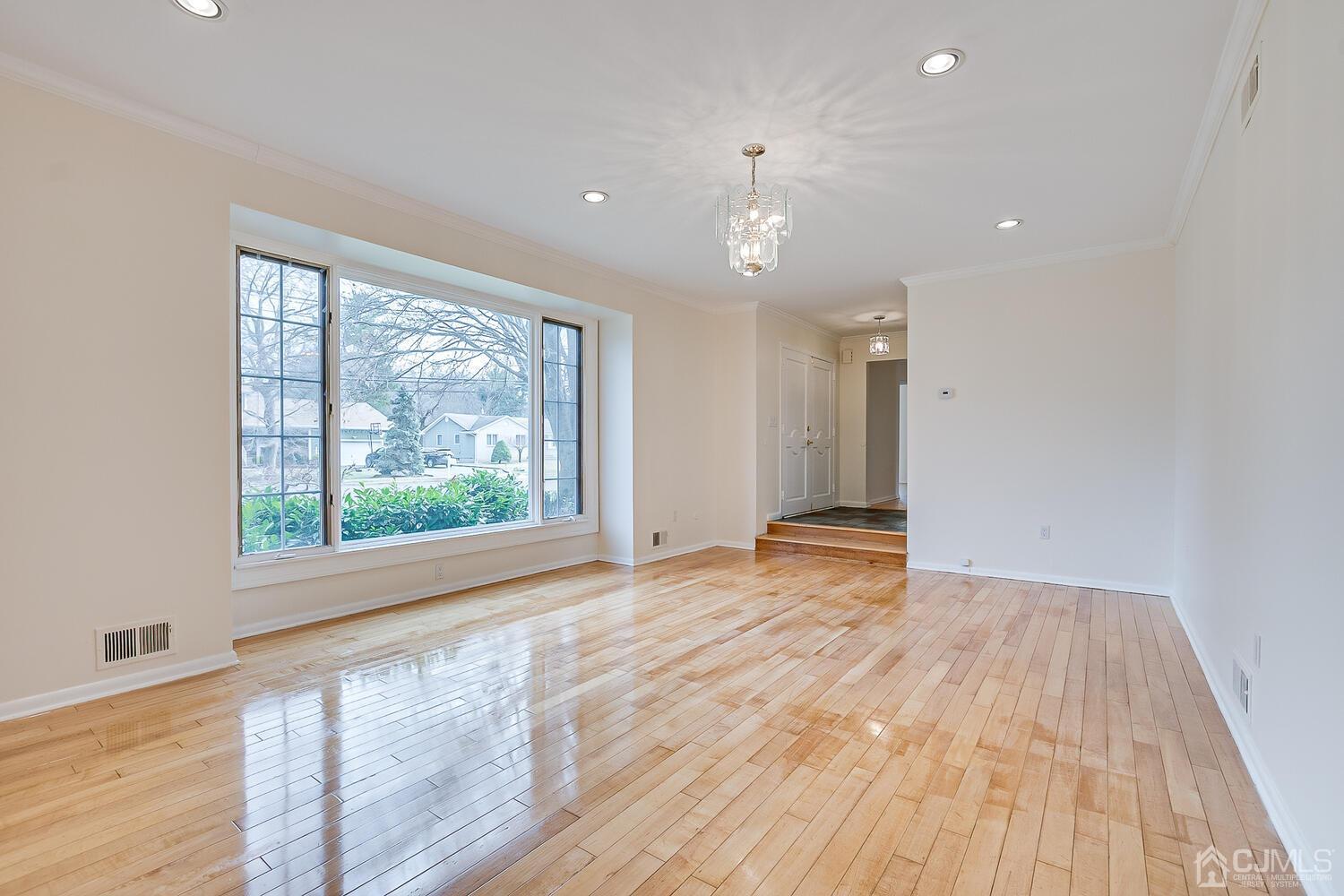 5 Robin Road Edison, NJ 08820 - Photo 4 of 43 a view of an empty room with wooden floor and a window