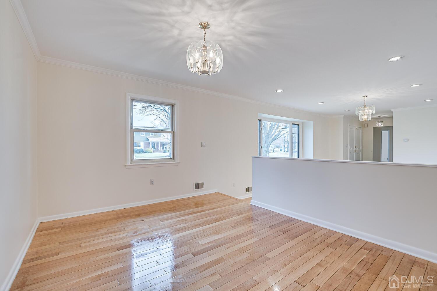 5 Robin Road Edison, NJ 08820 - Photo 6 of 43 a view of an empty room with wooden floor and a window