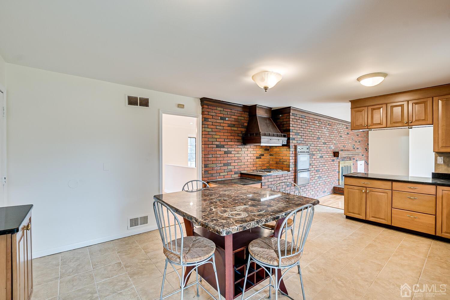 5 Robin Road Edison, NJ 08820 - Photo 10 of 43 a kitchen with stainless steel appliances granite countertop a kitchen island hardwood floor and a sink