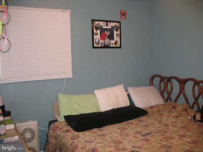 12409 Denley Road Silver Spring, MD 20906 - Photo 13 of 15 a bedroom with a bed and a couch