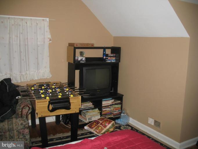 12409 Denley Road Silver Spring, MD 20906 - Photo 15 of 15 a room with furniture a flat screen tv and rug