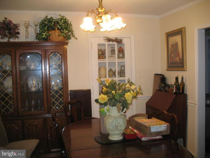 12409 Denley Road Silver Spring, MD 20906 - Photo 3 of 15 a living room with furniture flowerpot and a chandelier