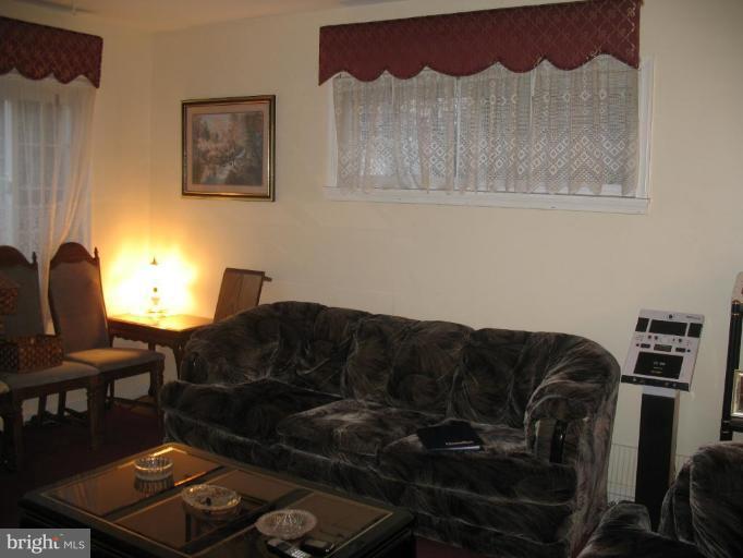 12409 Denley Road Silver Spring, MD 20906 - Photo 4 of 15 a living room with furniture and a chair