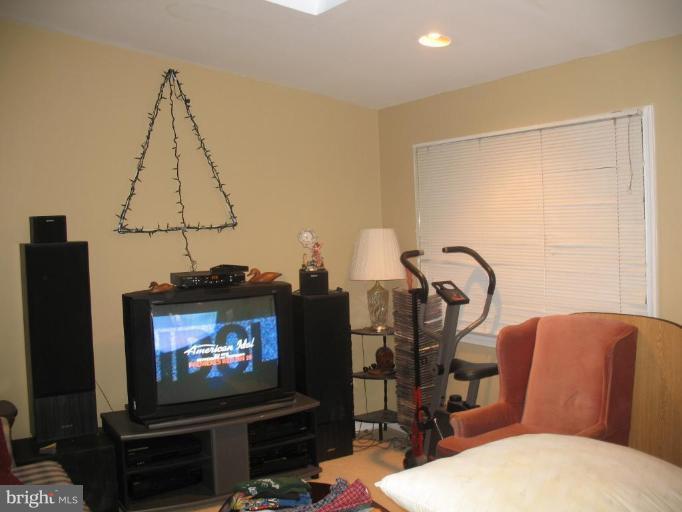 12409 Denley Road Silver Spring, MD 20906 - Photo 5 of 15 a living room with furniture a flat screen tv and a fireplace