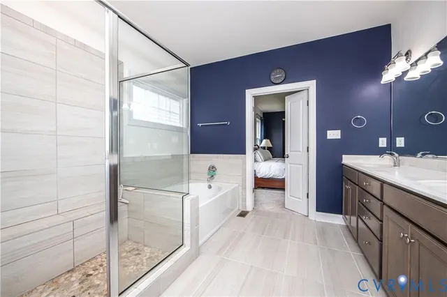 a bathroom with a double vanity sink a toilet a mirror and shower