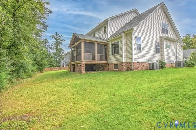 a view of a house with a yard and sitting area