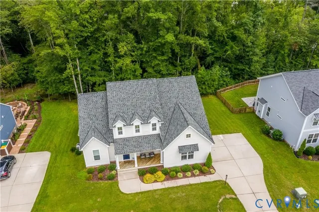 an aerial view of a house with swimming pool garden and patio