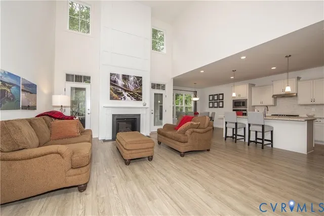 a living room with furniture kitchen view and a fireplace