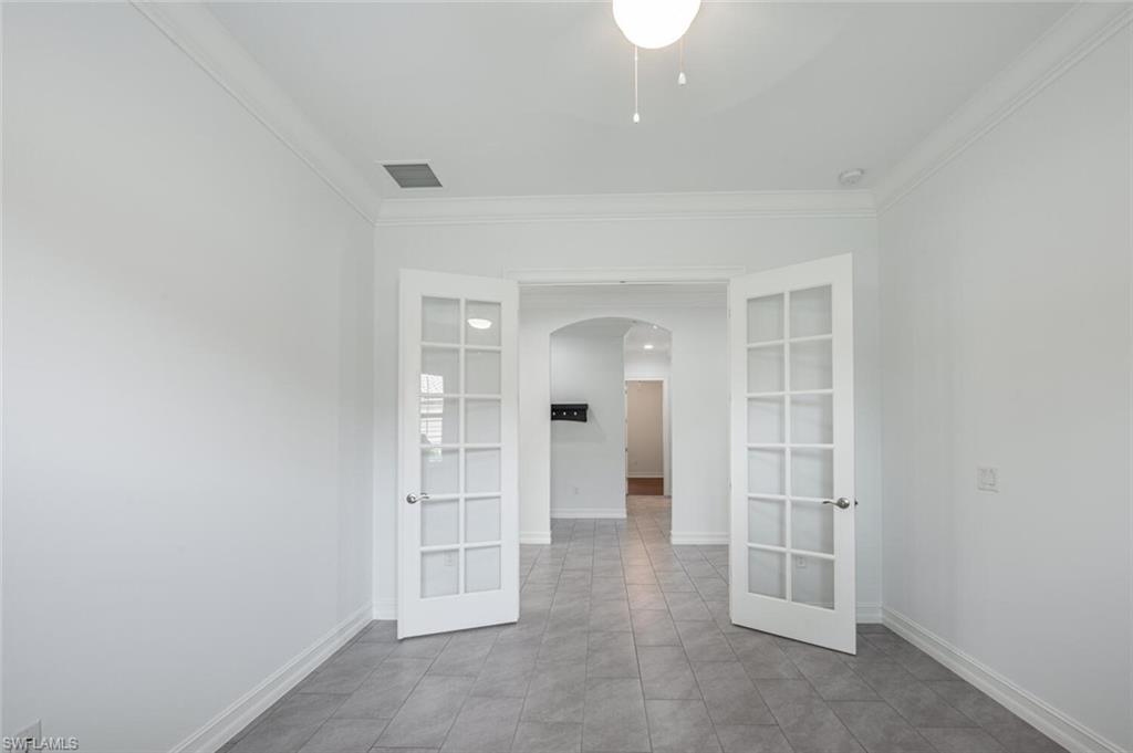 1488 Mockingbird Drive Naples, FL 34120 - Photo 11 of 38 an empty room with closet and windows