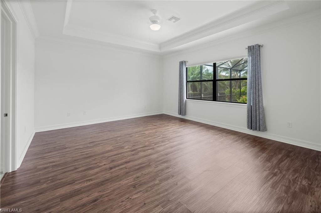 1488 Mockingbird Drive Naples, FL 34120 - Photo 13 of 38 wooden floor in an empty room with a window