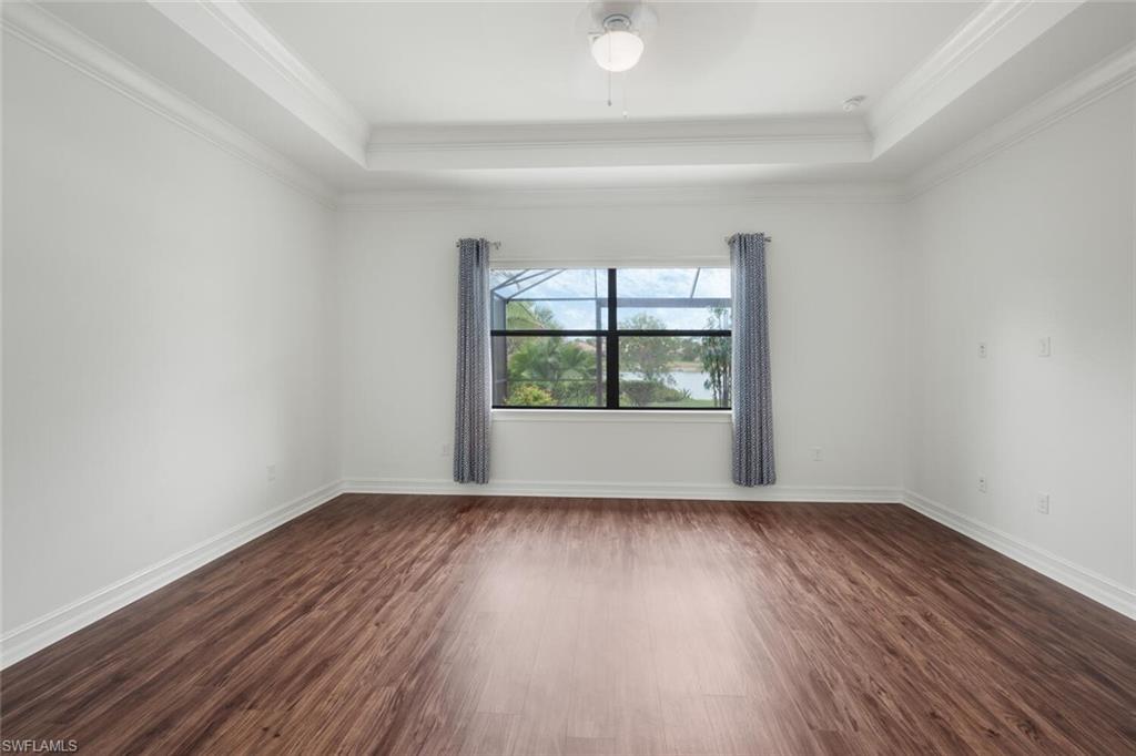 1488 Mockingbird Drive Naples, FL 34120 - Photo 14 of 38 wooden floor in an empty room with a window