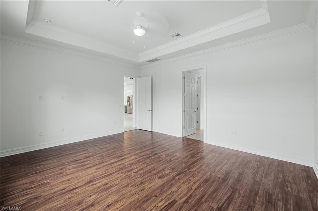 1488 Mockingbird Drive Naples, FL 34120 - Photo 16 of 38 a view of an empty room with wooden floor