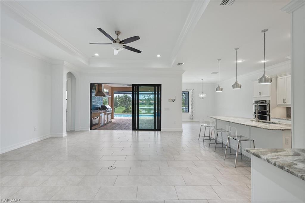 1488 Mockingbird Drive Naples, FL 34120 - Photo 3 of 38 a living room with stainless steel appliances granite countertop furniture and a kitchen view
