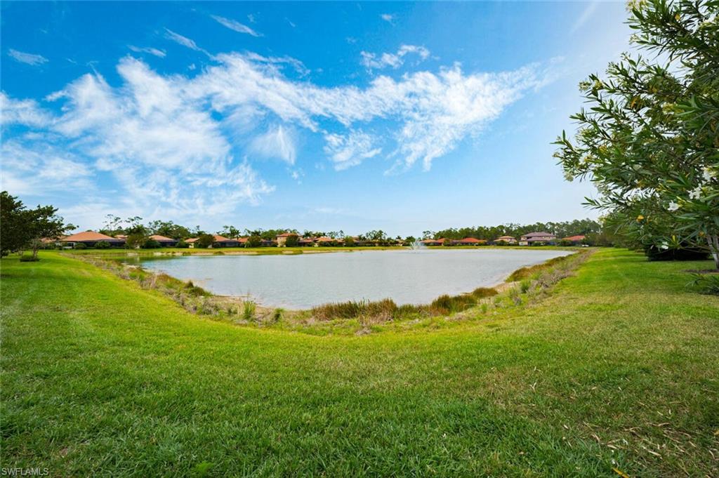 1488 Mockingbird Drive Naples, FL 34120 - Photo 34 of 38 a view of a lake with houses in the back
