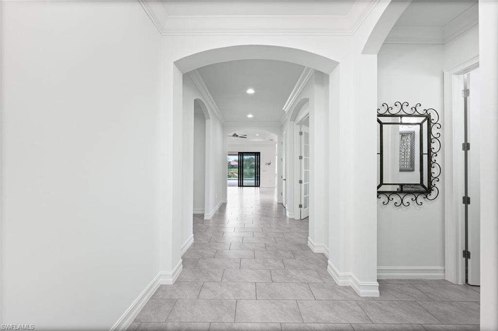 1488 Mockingbird Drive Naples, FL 34120 - Photo 4 of 38 a view of a hallway with wooden floor