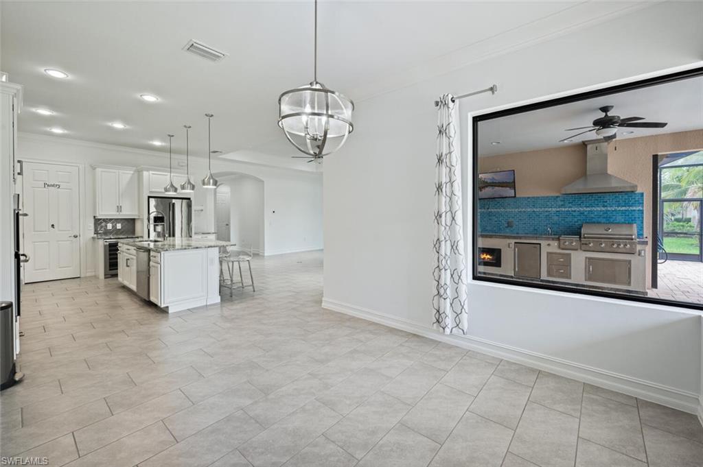 1488 Mockingbird Drive Naples, FL 34120 - Photo 8 of 38 a view of a kitchen with refrigerator and microwave