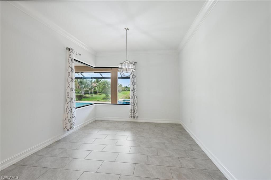 1488 Mockingbird Drive Naples, FL 34120 - Photo 9 of 38 a view of an empty room with windows