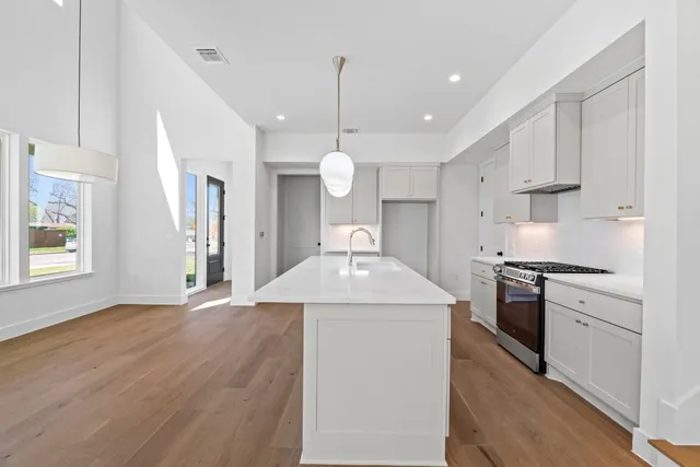 a kitchen with a stove a sink and a refrigerator